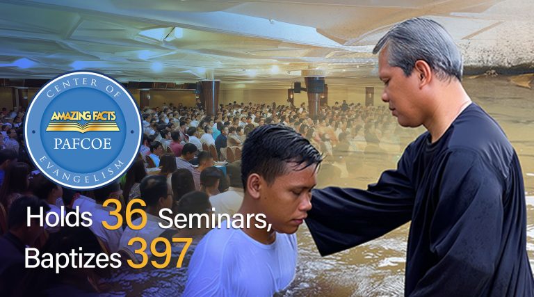 Promotional image showing a baptism in progress: a man stands in water with his head bowed while another man places a hand on his shoulder. In the background, a large crowd gathers inside a church. A circular Amazing Facts logo appears at the top left. Overlaid text reads, ‘ PAFCOE Holds 36 Seminars, Baptizes 397.’