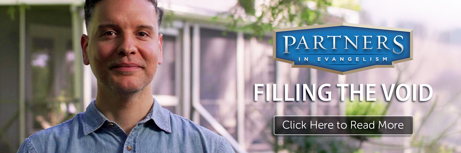 Smiling man standing next to a sign that says "Partners in Evangelism" and a button that says, "Click Here to Read More" 